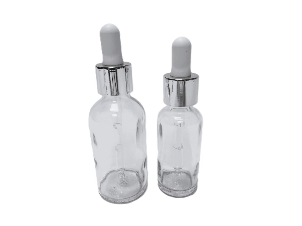 Frasco-vidrio-transparente-cuentagotas-urea-metalizada-plata-tetina-blanca-Fusté